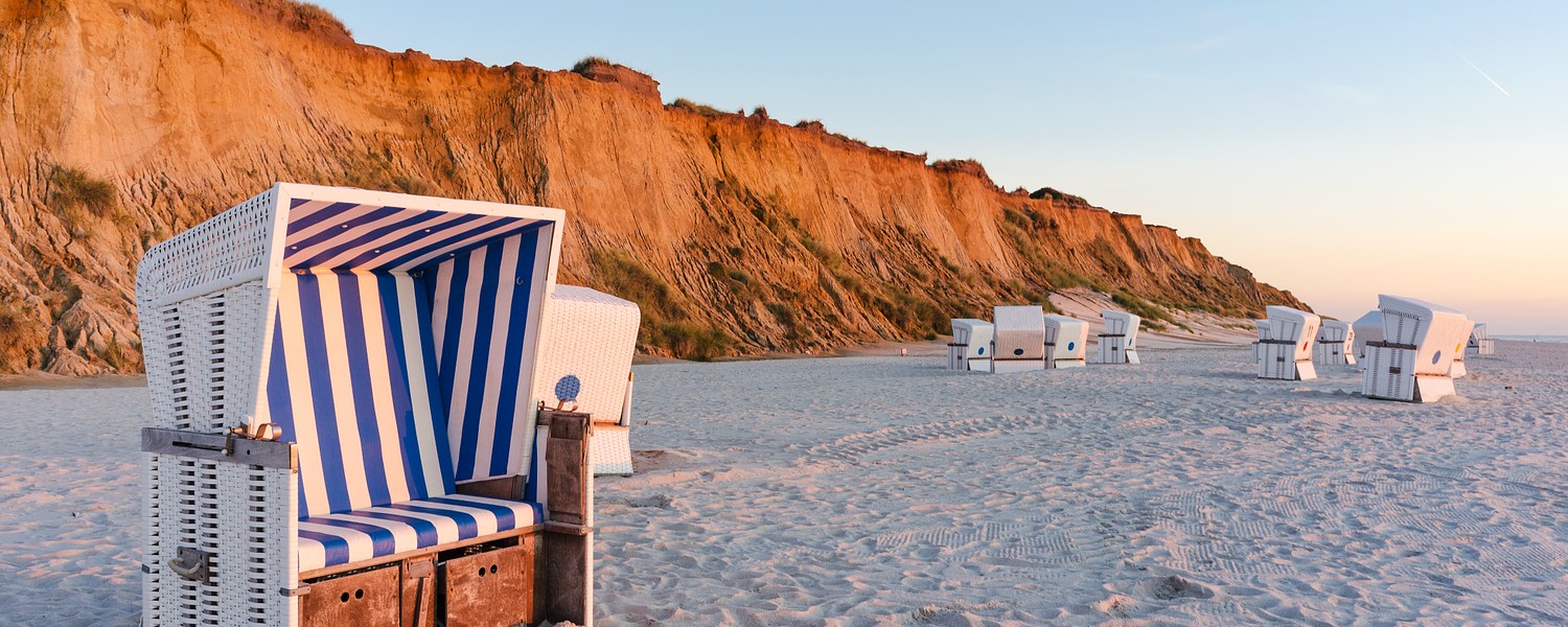 Beach chairs with Red Cliff near Kampen on the island of Sylt, Schleswig-Holstein, Germany