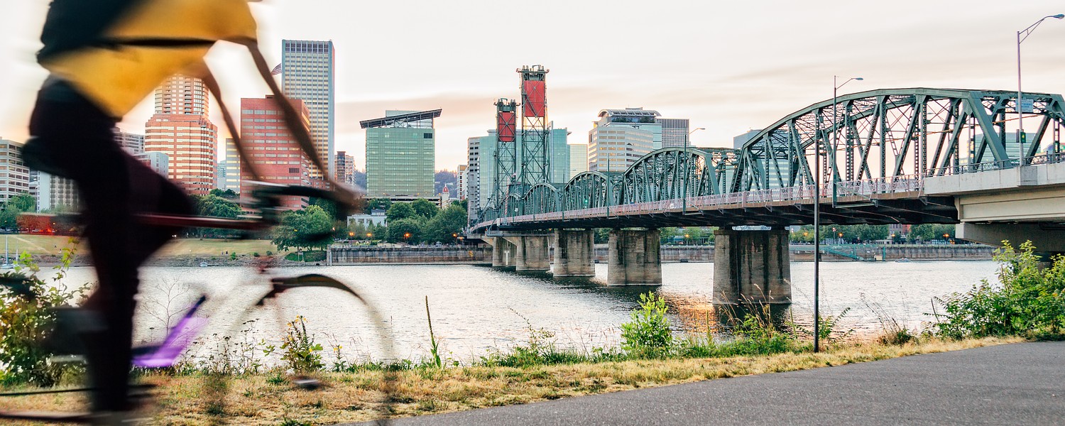 Man biking towards a bridge in Portland
