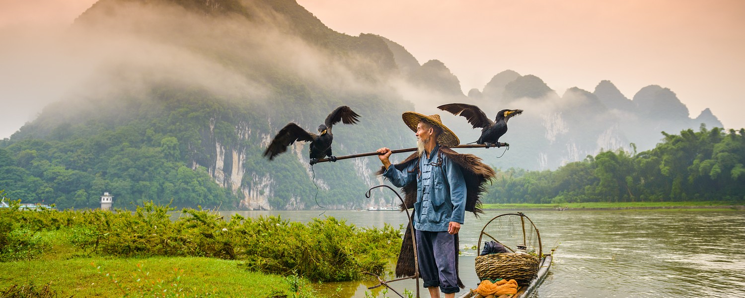 A traditional cormorant fisherman works on the Li River Yangshuo, China.