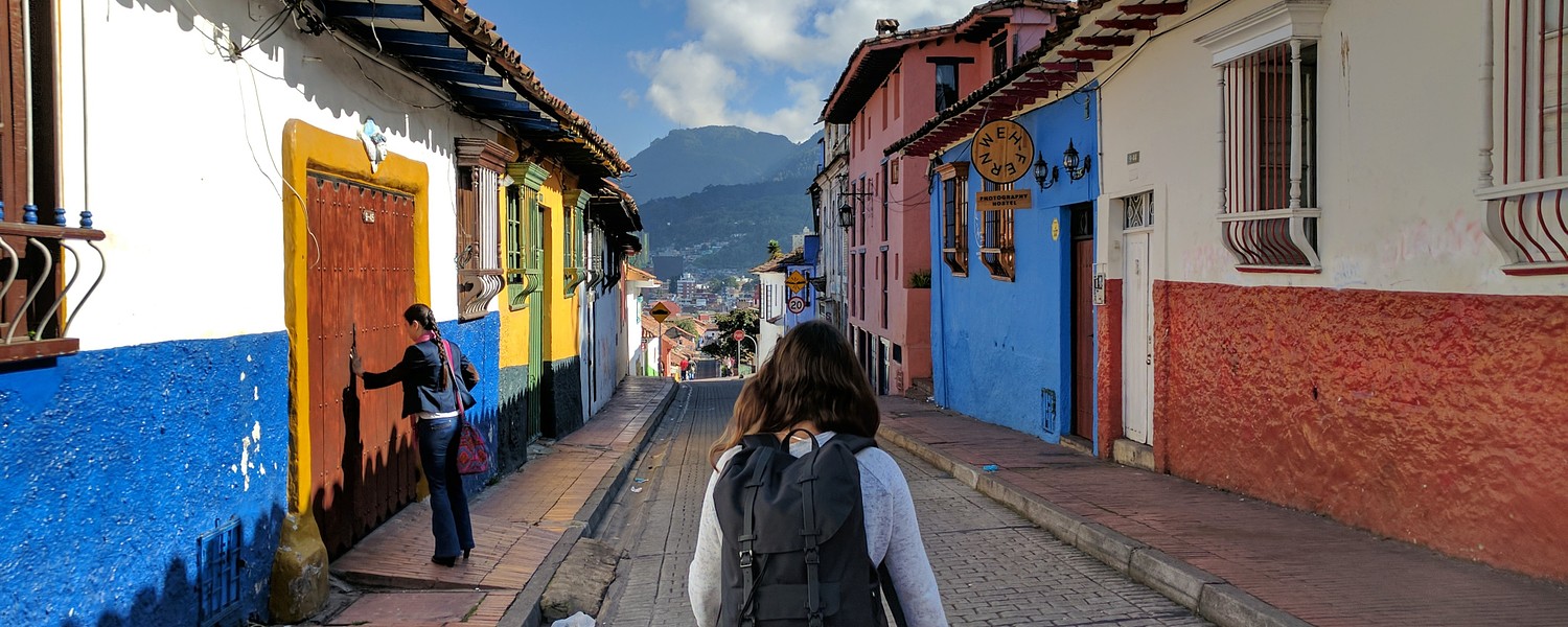 woman marching through the Candelaria neighbourhood of Bogota